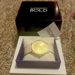 Movado Bold women’s watch with  white leather strap, yellow gold dial.